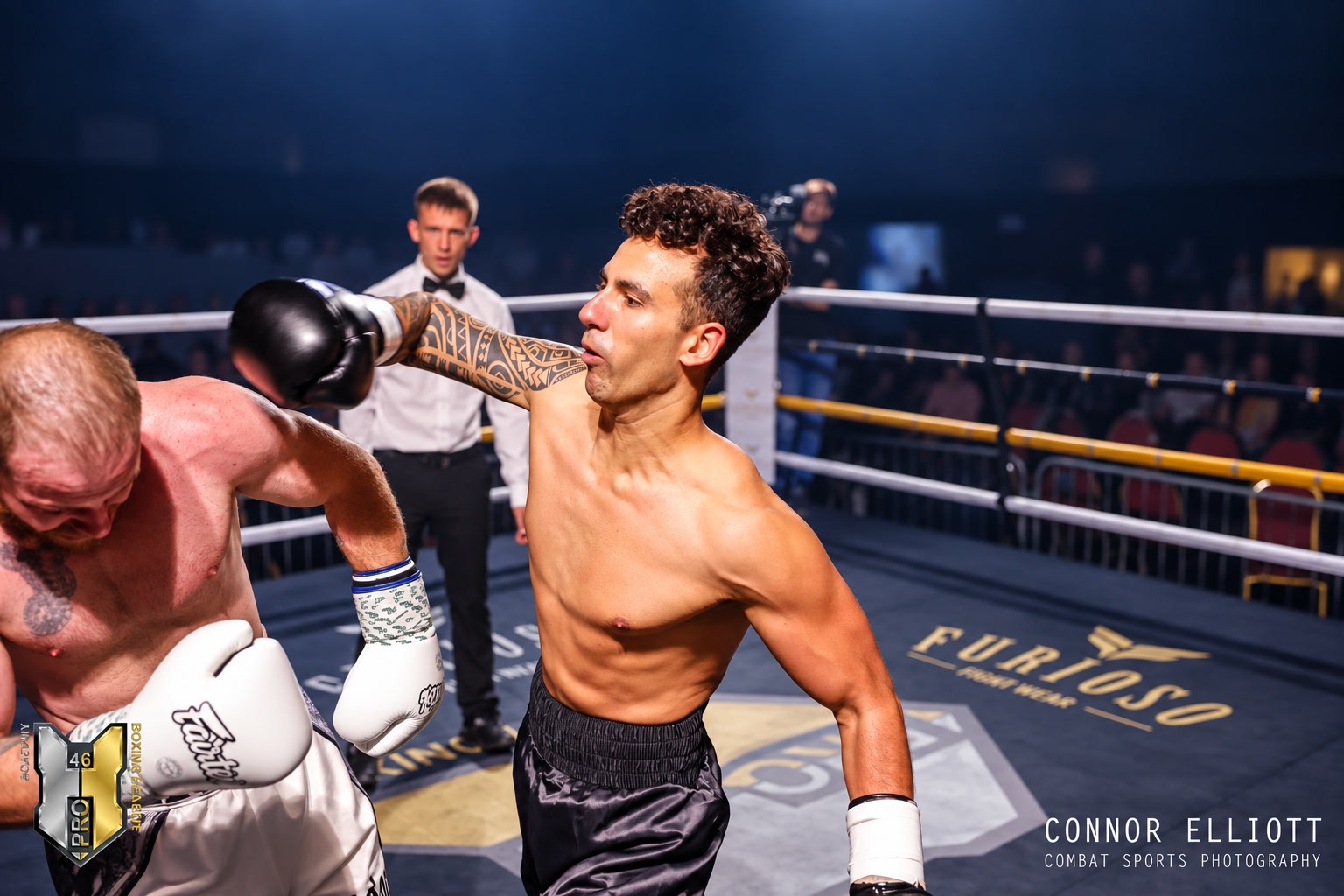 Zane Ward boxing in a ring, throwing a punch during a bout